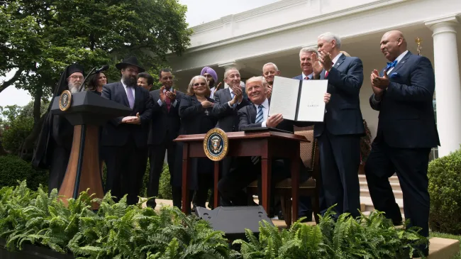 President Trump signs an executive order in the Rose Garden